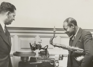 Amerikaans jazzmusicus en saxofonist Coleman Hawkins beluistert een zojuist gemaakte grammofoonopname, 1935. Fotograaf onbekend/Vereenigde Fotobureax, Collectie Nationaal Archief.